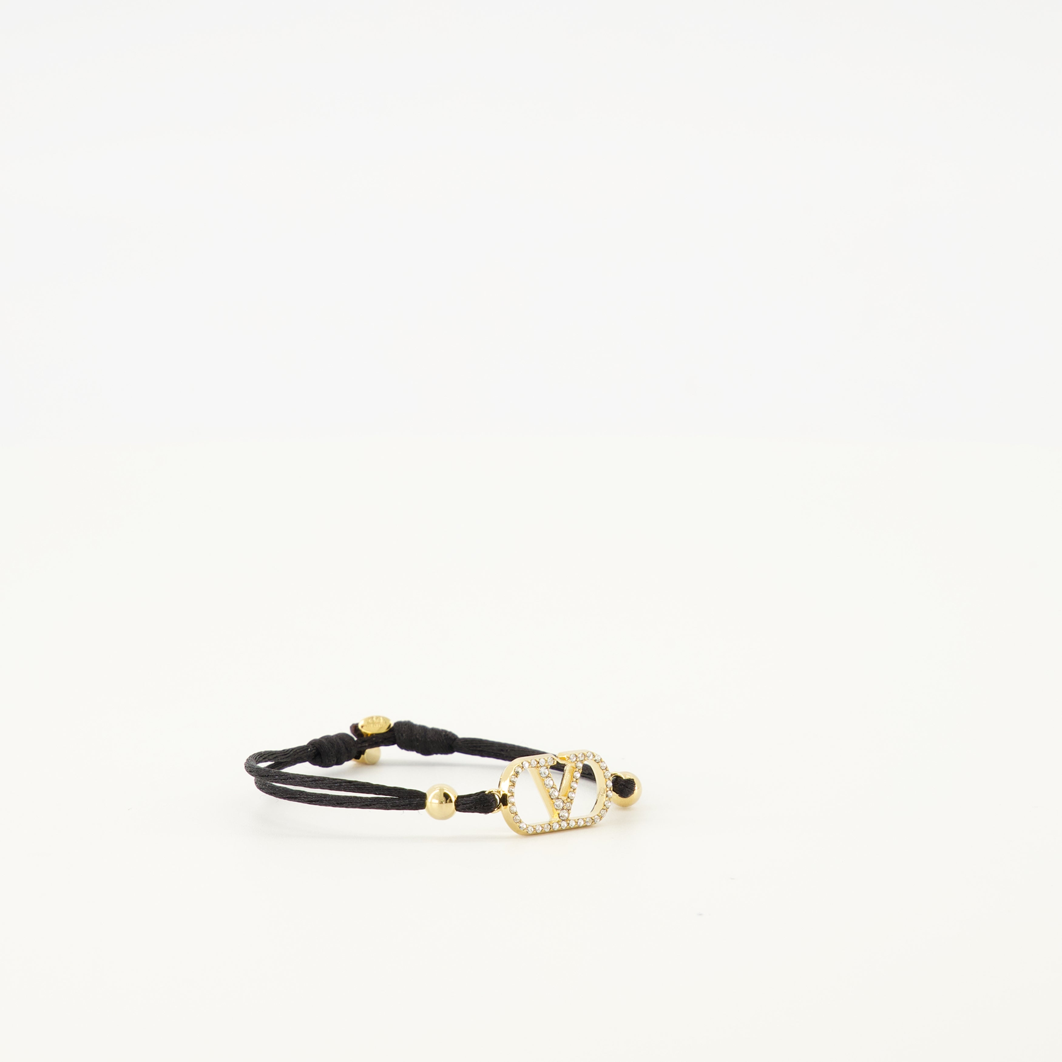 Image of the Vlogo bracelet with black cord and Swarovski® crystals by Valentino Garavani for Women - Spring-Summer 2026 - Detailed View 2