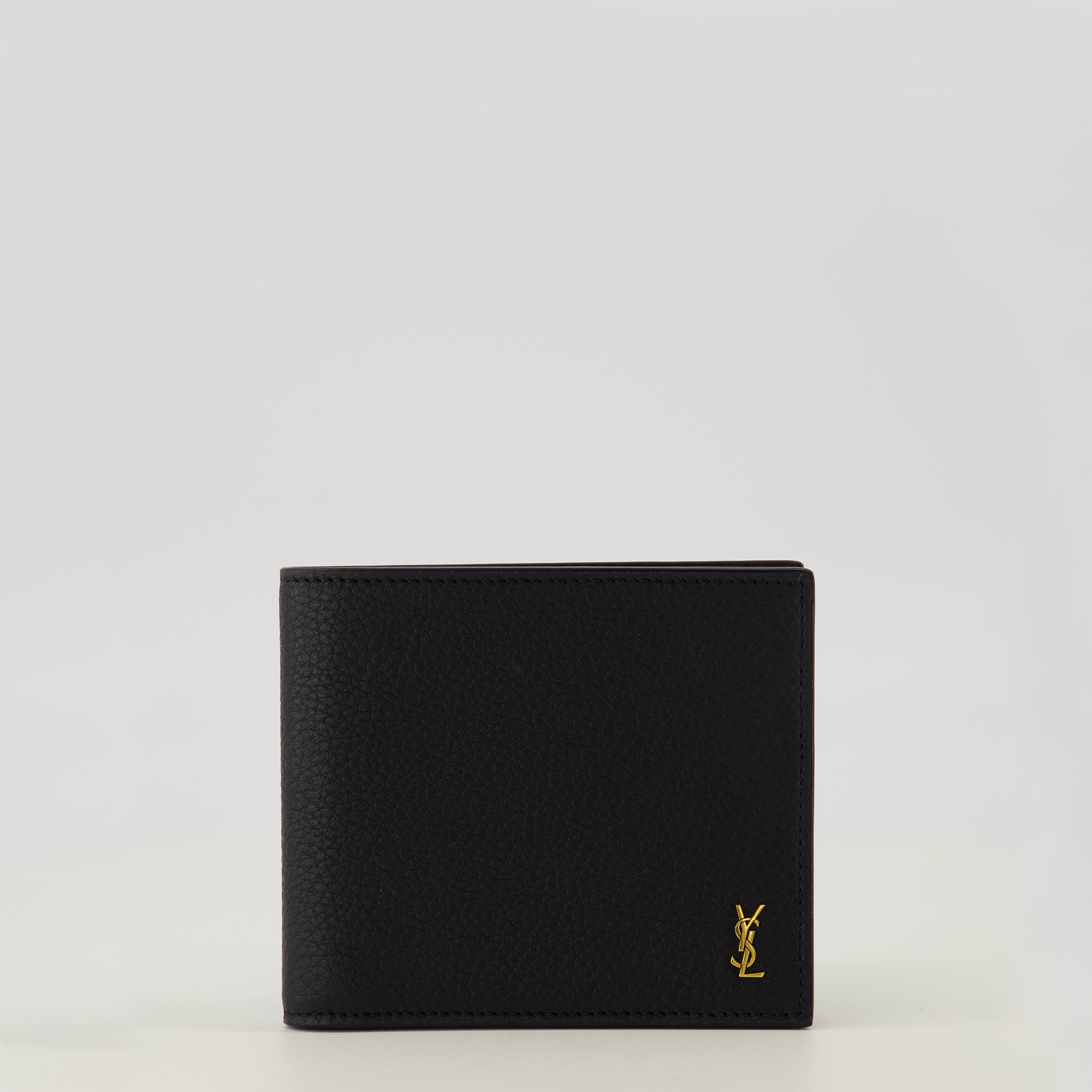 Image of the Tiny Cassandre black and gold wallet from the brand Saint Laurent for Men - Spring-Summer 2026 - Front View
