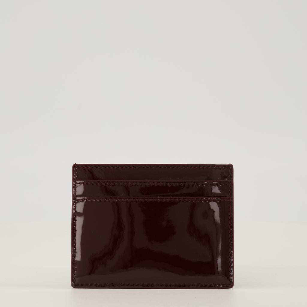 Image of the Burgundy patent leather cardholder by Saint Laurent for Women - Spring-Summer 2026 - Back View