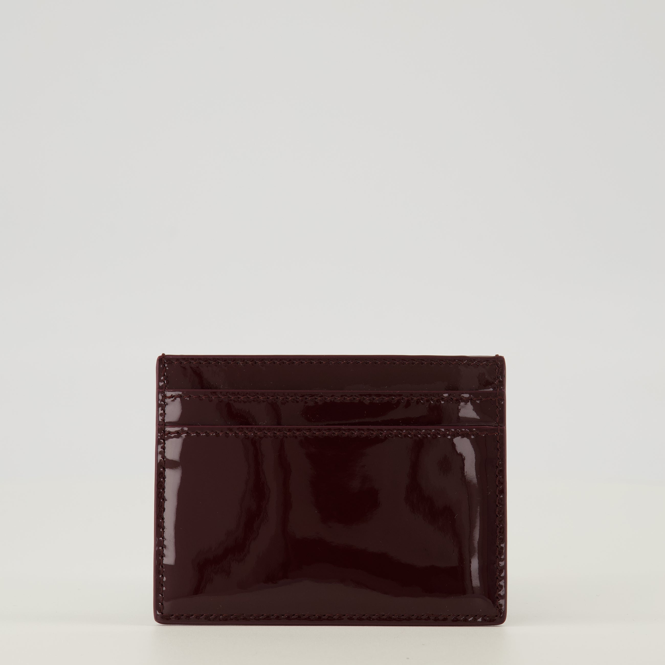 Image of the Burgundy patent leather cardholder by Saint Laurent for Women - Spring-Summer 2026 - Back View