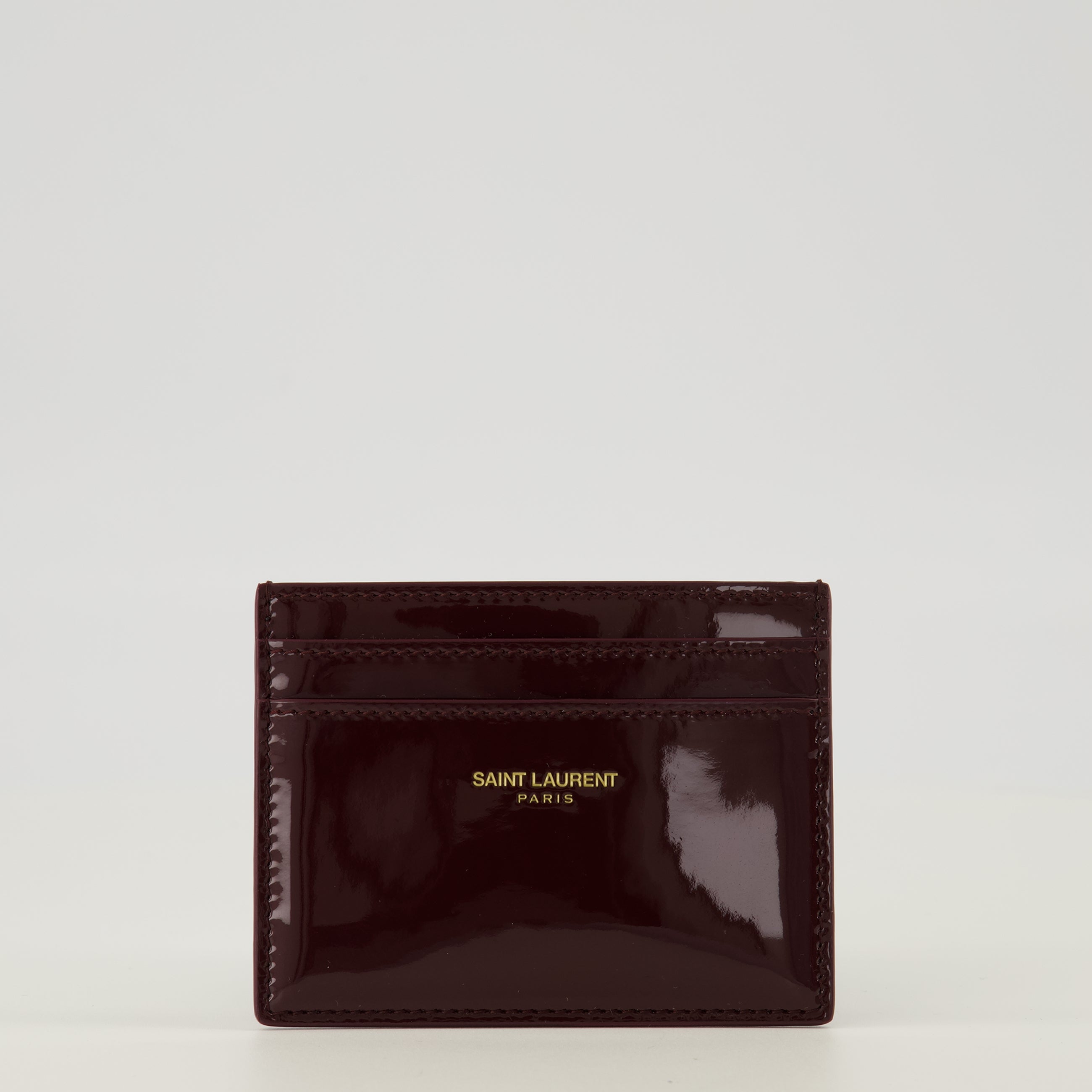 Image of the Burgundy patent leather cardholder by Saint Laurent for Women - Spring-Summer 2026 - Front View
