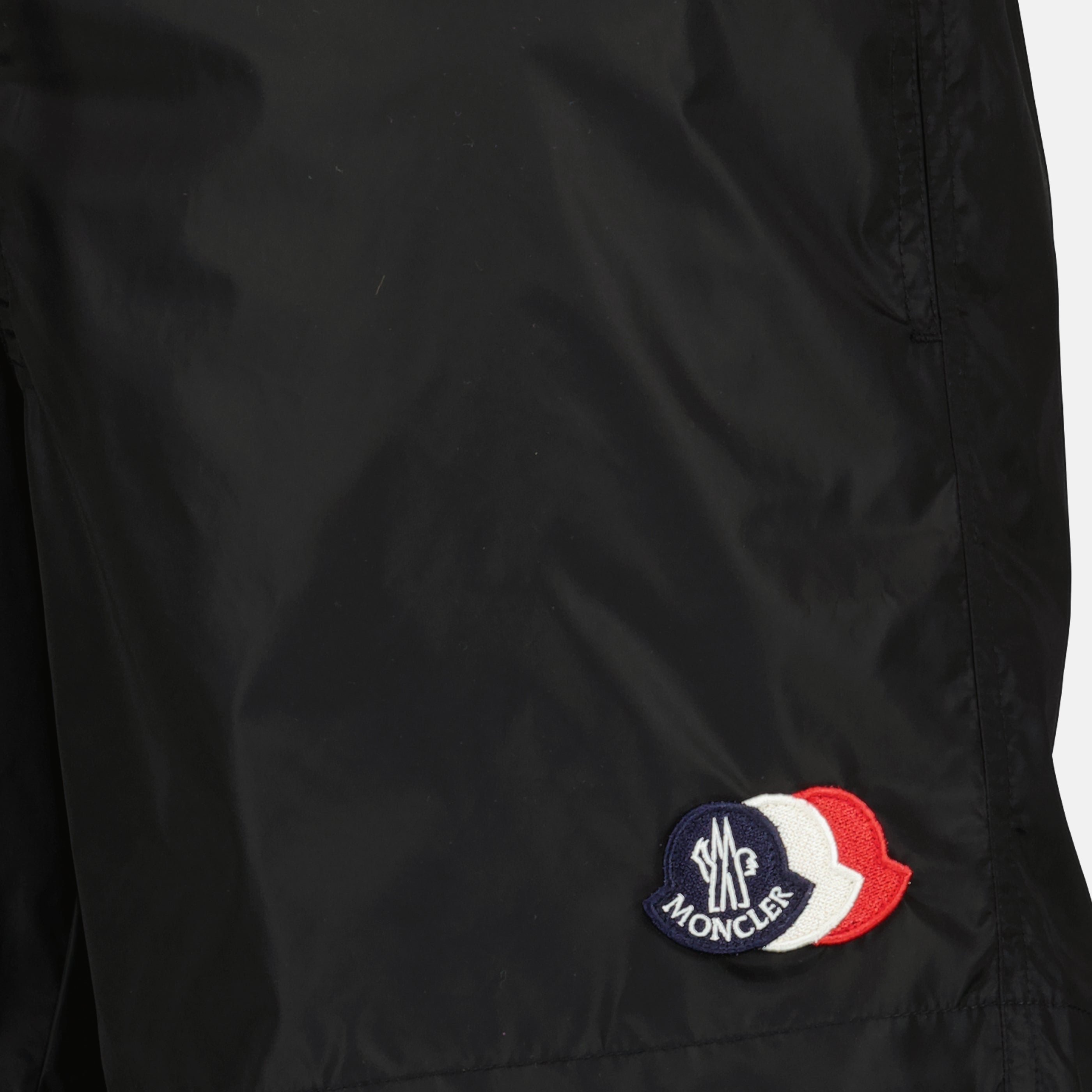 Image of the black logo nylon swim shorts by Moncler for Men - Spring-Summer 2026 - Detailed View_1