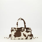 Imagen del bolso mini Bonnie con estampado de vaca de la marca Prada para mujer - Temporada Primavera-Verano 2026 - Vista Trasera