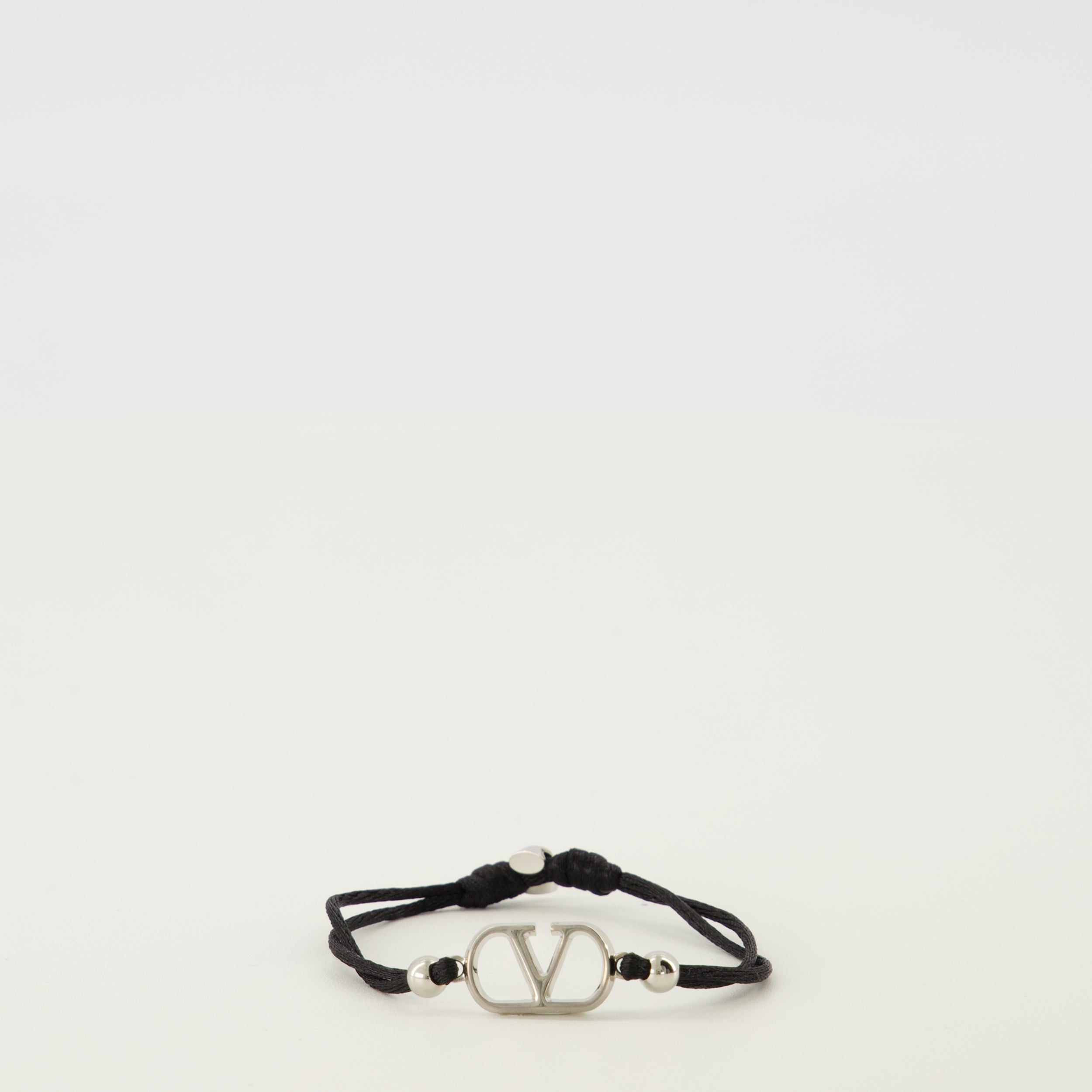 Image of the VLogo bracelet with black cord from the brand Valentino Garavani for Men - Spring-Summer 2026 - Front View