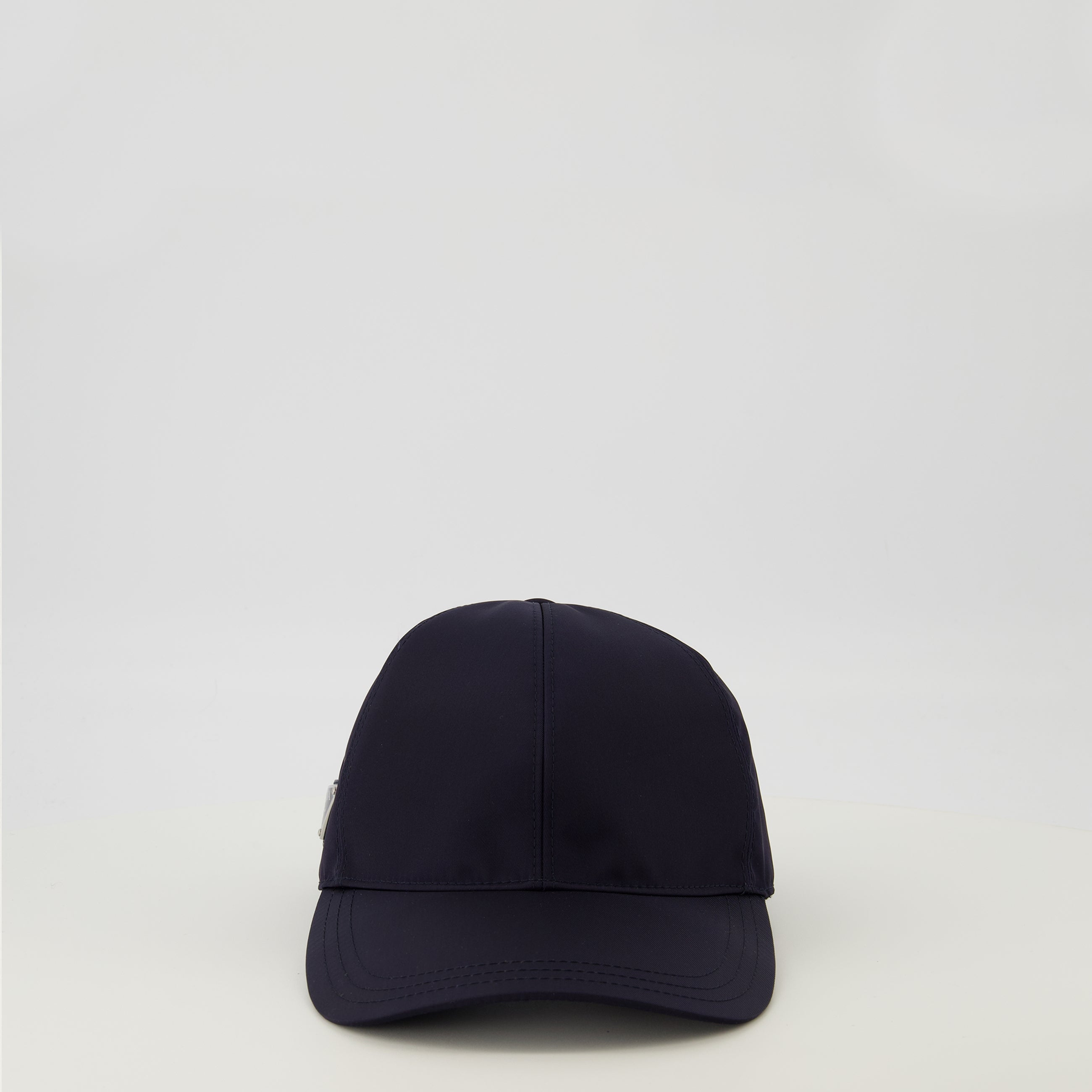 Image of the Prada men's navy blue Re-Nylon cap - Spring-Summer 2026 - Front View