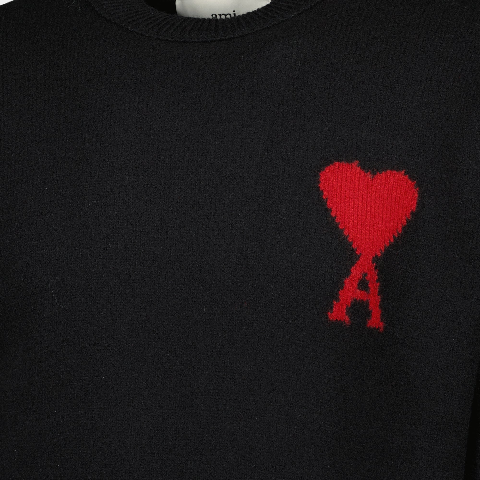 Image of the AMI black heart sweater from the brand Ami PARIS for Unisex - Spring-Summer Season 2026 - Detailed View_1