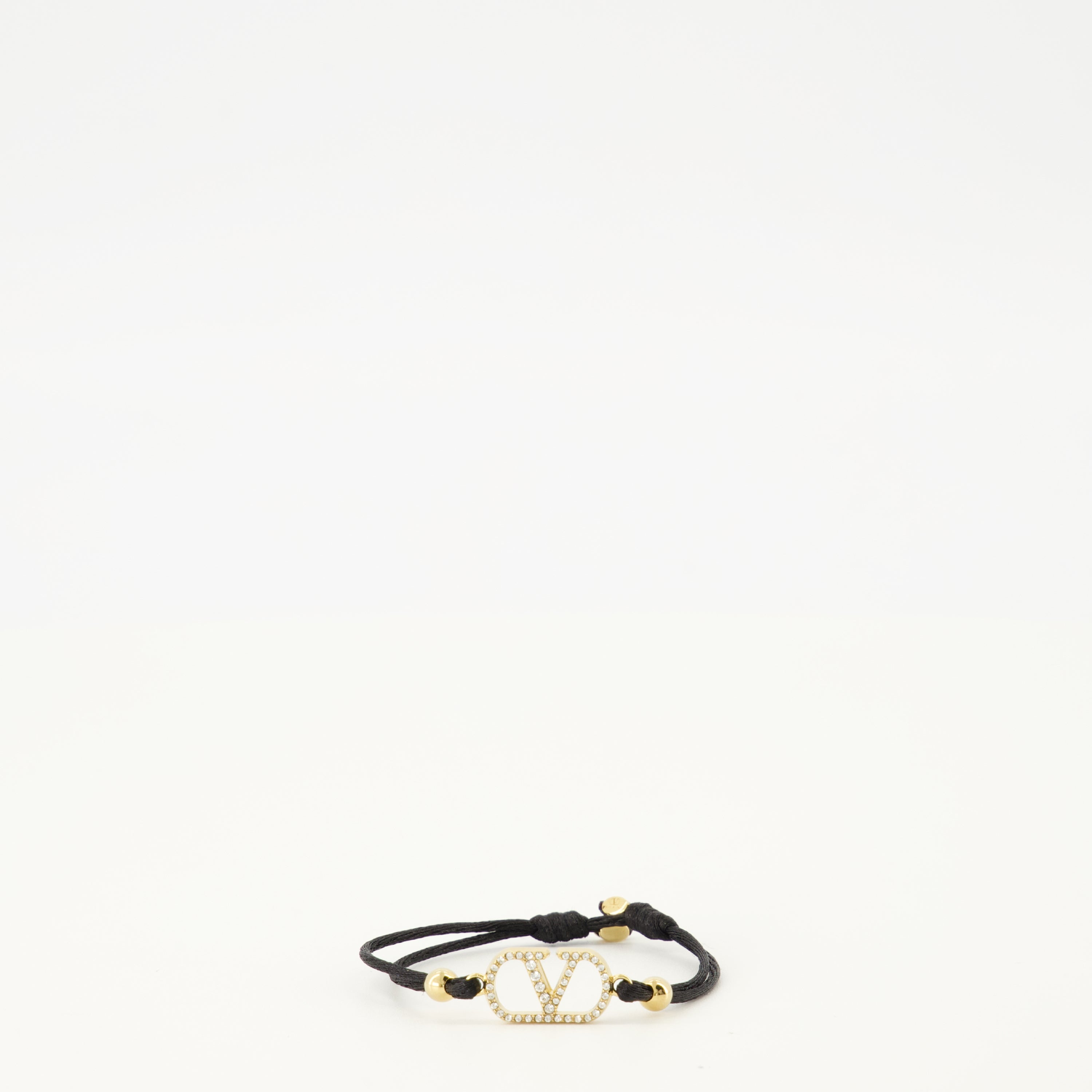 Image of the Vlogo bracelet with black cord and Swarovski® crystals by Valentino Garavani for Women - Spring-Summer 2026 - Front View