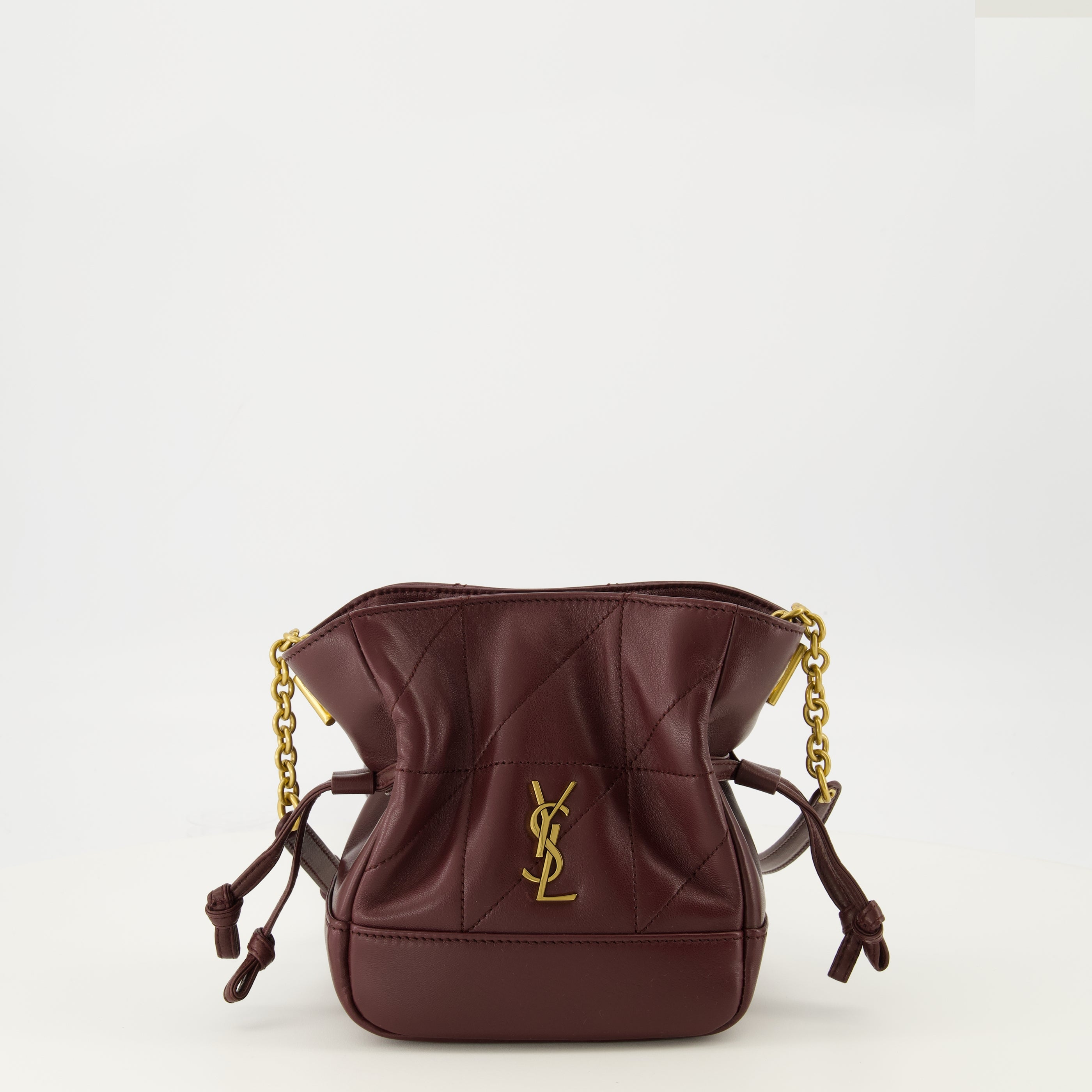 Image of the Saint Laurent women's Jamie mini bucket bag in burgundy leather - Spring-Summer 2026 season - Front view