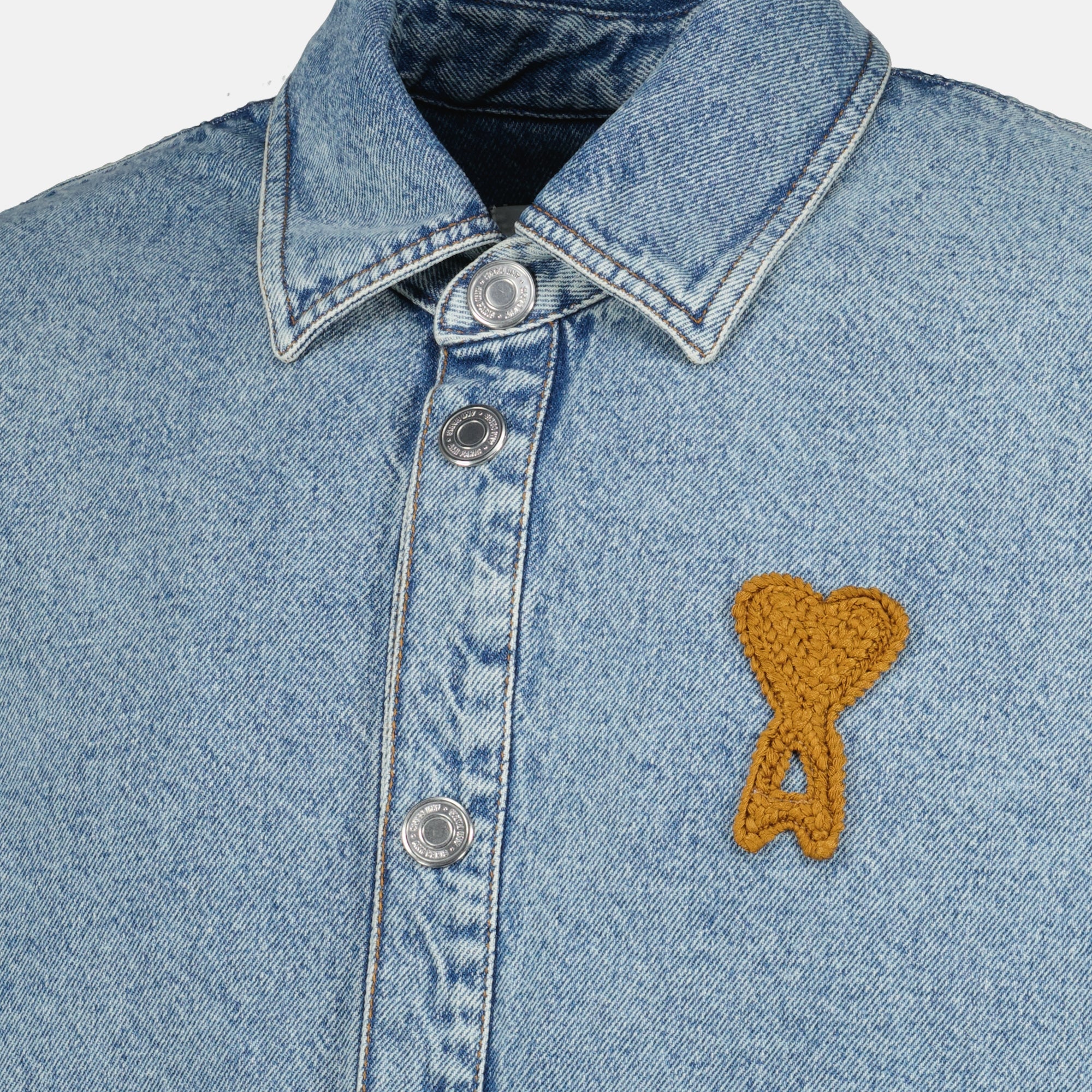 Image of the AMI blue crochet heart denim shirt by Ami PARIS for Unisex - Spring-Summer 2026 - Detailed View_1