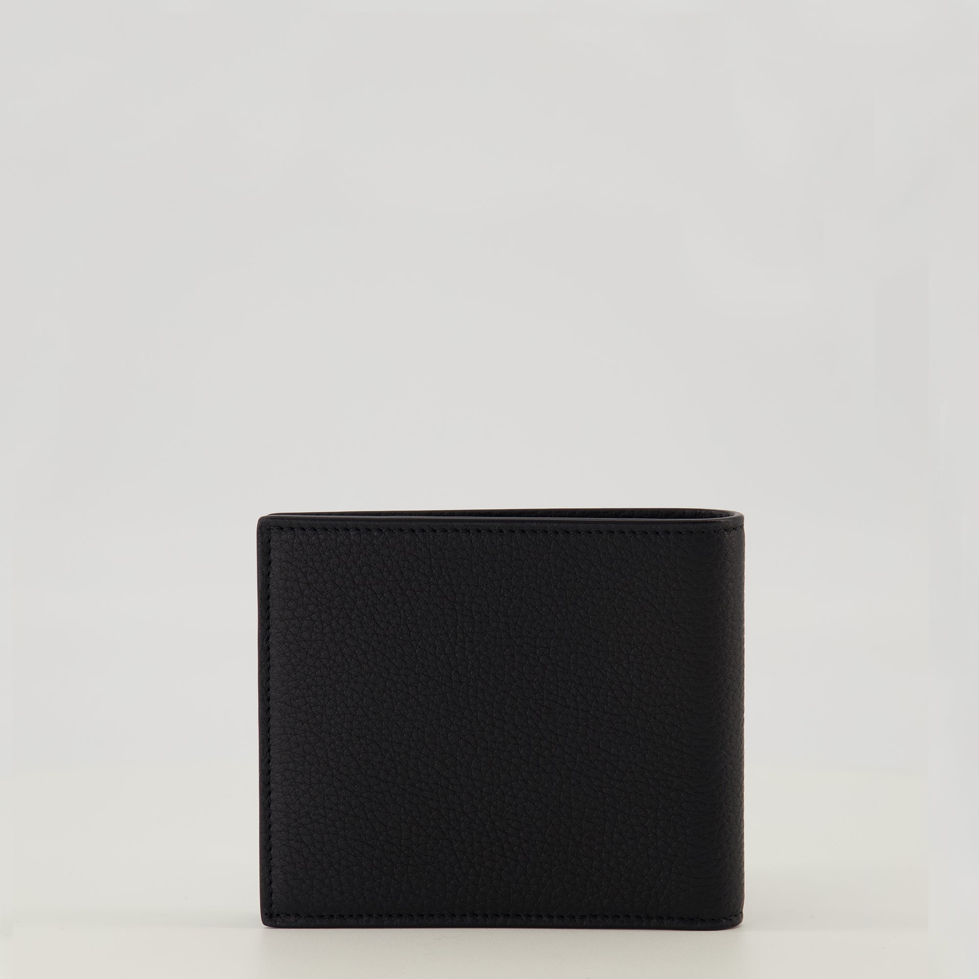 Image of the Tiny Cassandre black and gold wallet from the brand Saint Laurent for Men - Spring-Summer 2026 - Back View