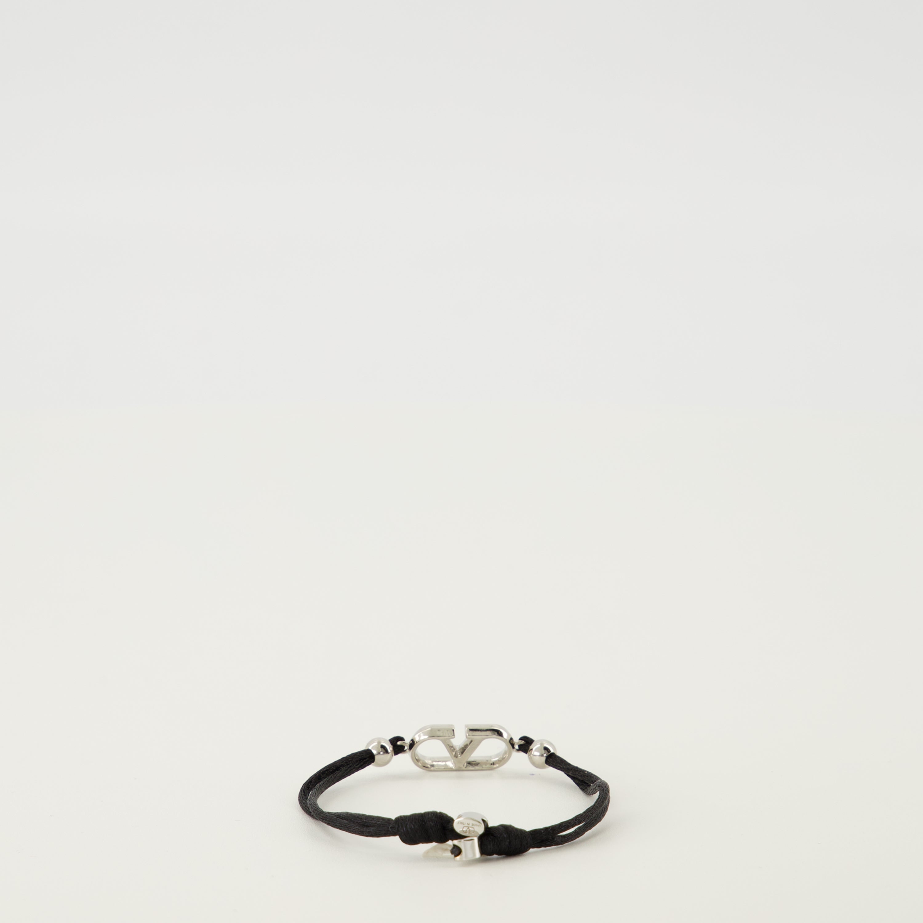 Image of the VLogo bracelet with black cord from the brand Valentino Garavani for Men - Spring-Summer 2026 - Back View